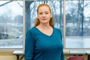 Parent carer advisor, Elaine standing stoicly in classroom